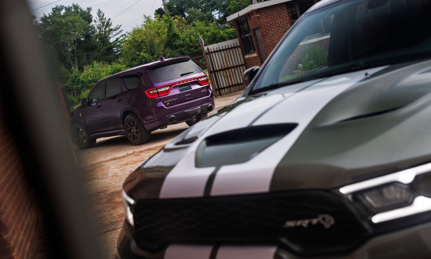2026 Dodge Durango SRT Hellcat Jailbreak in Green Machine (front). A Jailbreak Custom Color program will allow select Dodge customers to paint their Durango SRT Hellcat Jailbreak in nearly any color imaginable, including Stryker Purple (shown at rear).